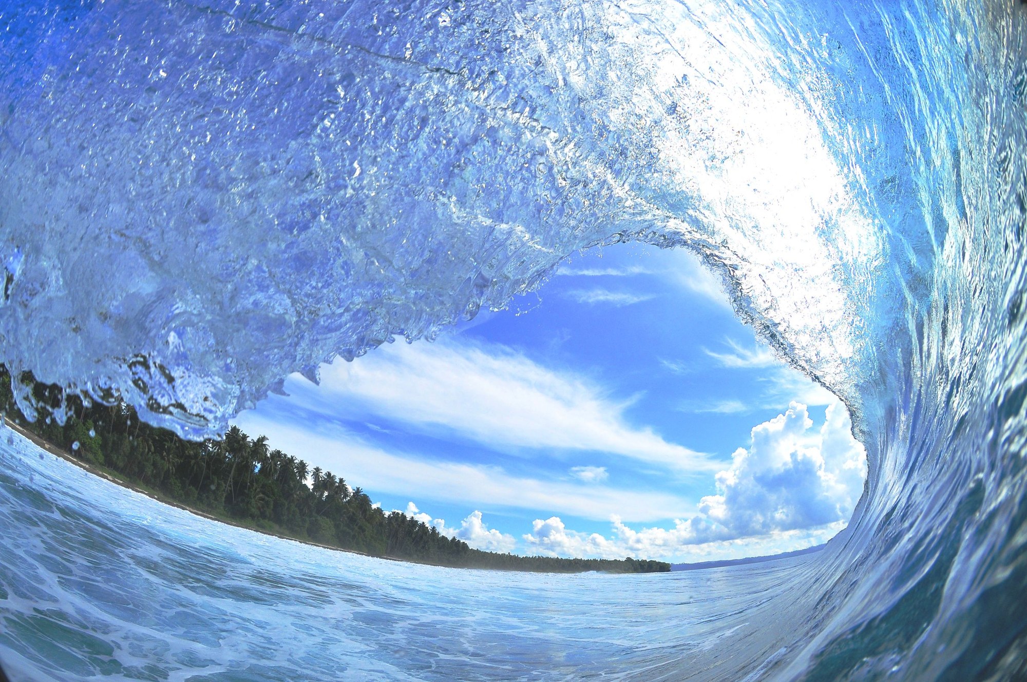 An empty ocean barrel curling overhead, photographed by Victor Dutra; shown in black and white